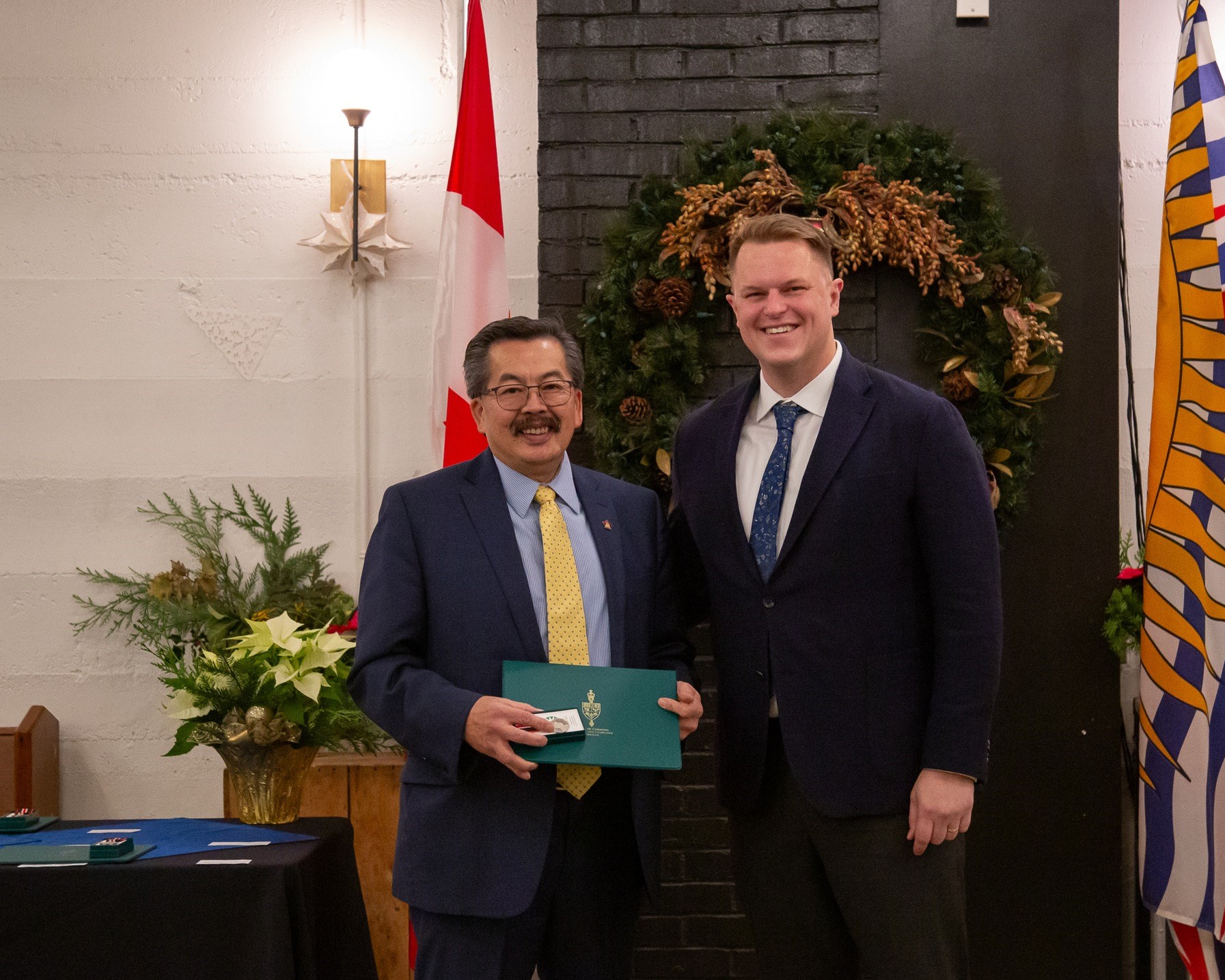 Wallace Mah Recieving the King Charles Medal from MP Brad Vis